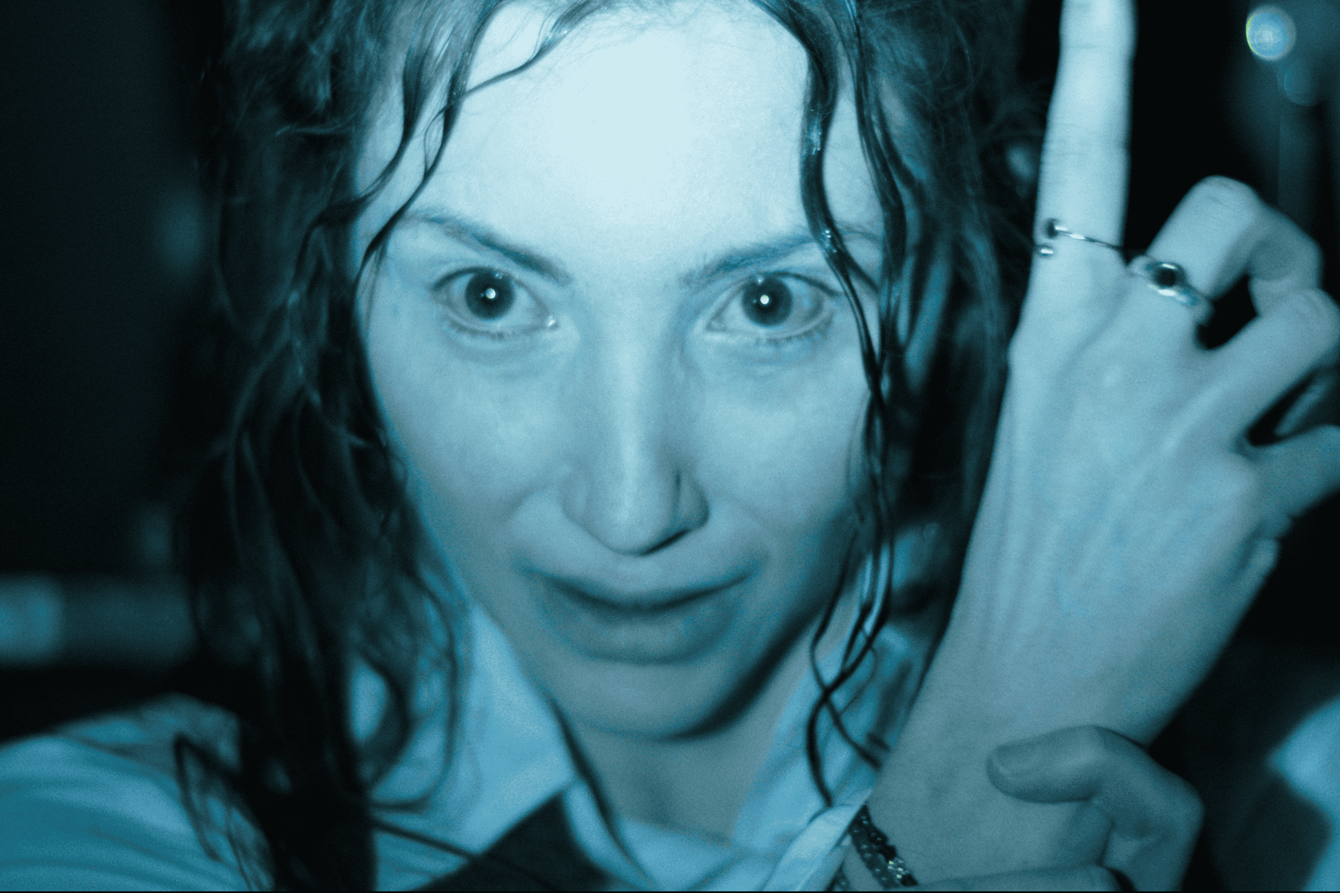 Promotional image of Hokum, featuring a supernatural entity pointing up at something.
